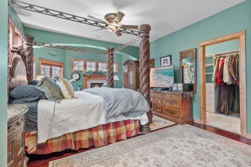 Primary bedroom suite with view toward sitting area with fireplace and door to full length covered deck. Entry to first walk-in closet shown. Wired LAN available