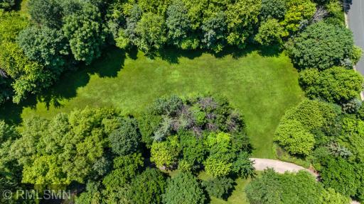 Ariel shot of lawn and street with driveway in the foreground.