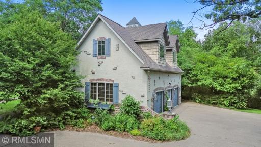 Side view of attached 3-car heated garage with spacious office / bonus room above.