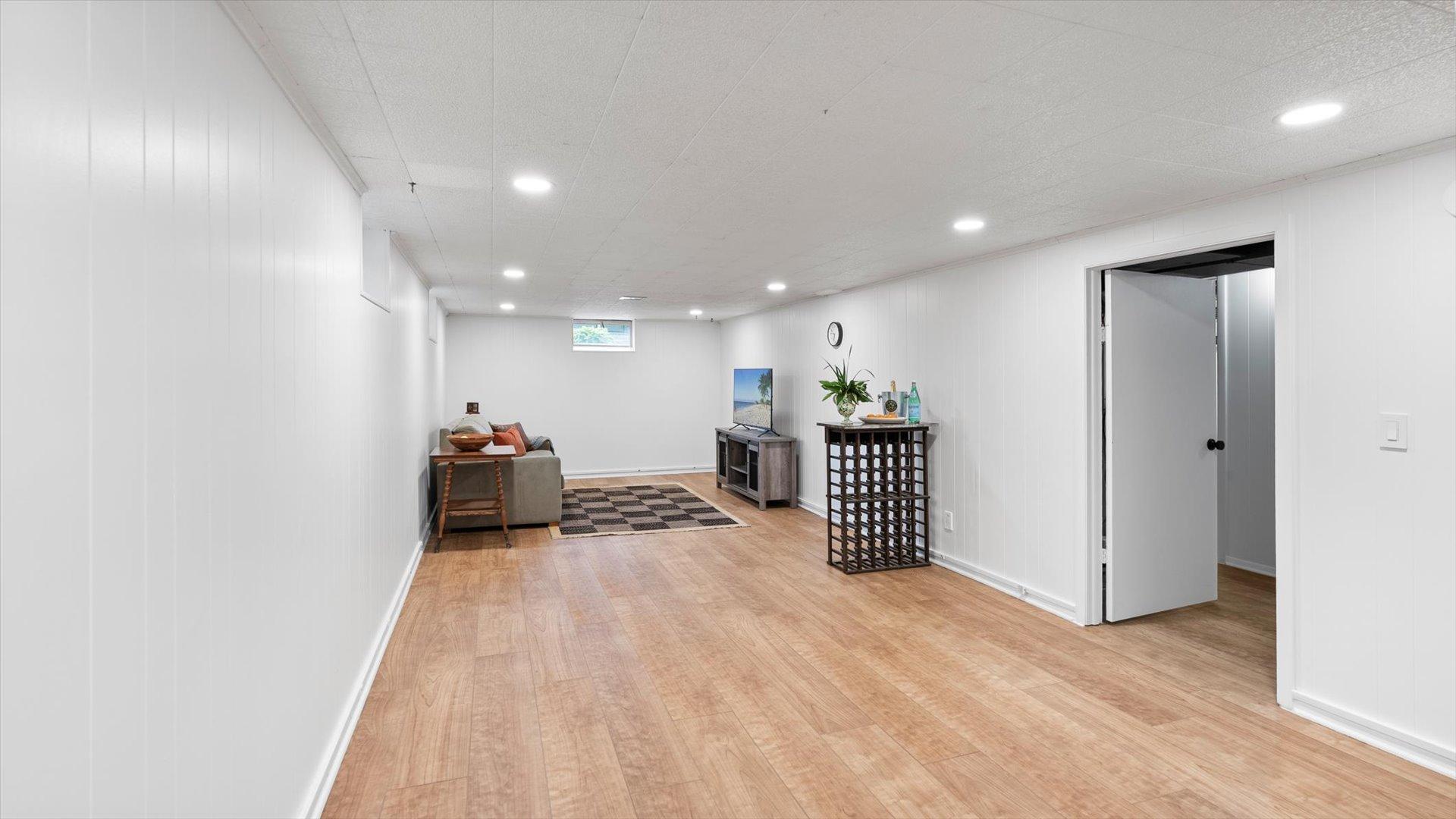Extra large family room in the basement with new LVP flooring in 2024.