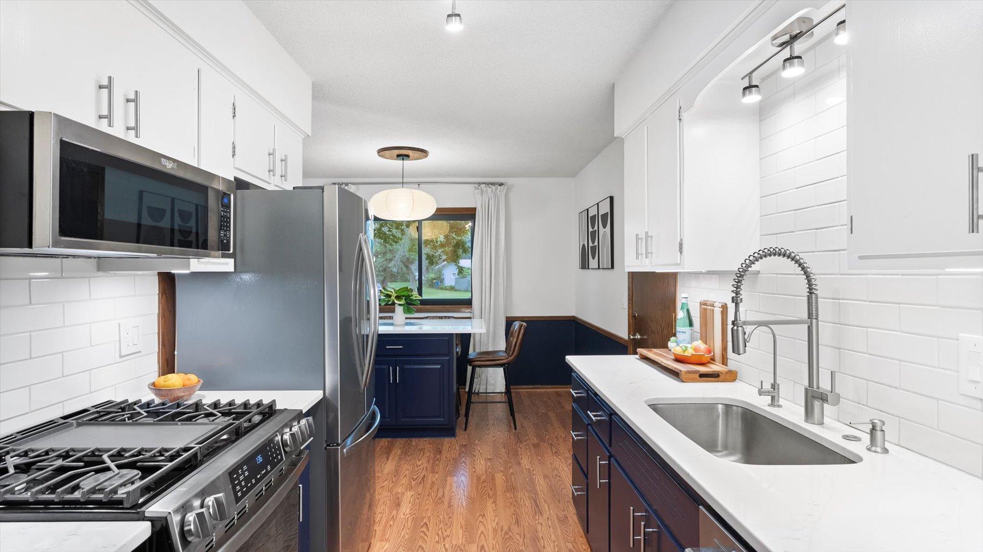 Deep kitchen sink and garbage disposal installed within the last few years, along with white quartz countertops.