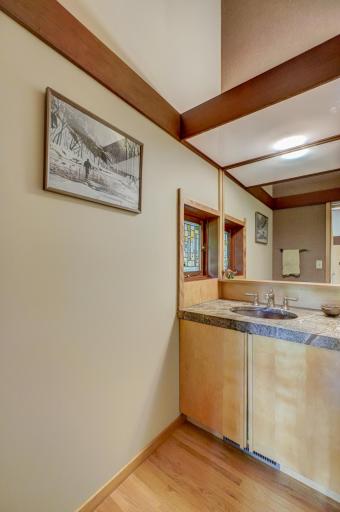 The main floor half bath with the textured granite countertop that is reiterated throughout the home.