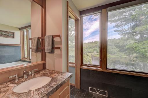 The exquisite second floor bathroom is a lesson in flex-space design. The doorway seen here separates the space into a 3/4 bath on the north and a full bath on the south.