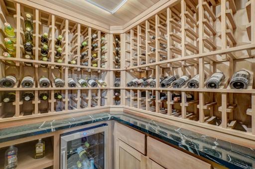 One of the fun features in the lower level is this custom wine pantry added in 2019. It has maple shelving, a soapstone counter, custom cabinets, and a beverage refrigerator.