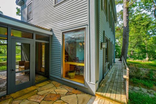 The stone patios represent another example of materials and design integration that so beautifully ties elements together. This patio is just outside the south screen porch.