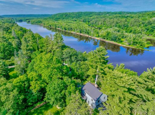 Tucked in a private wooded setting, the home still enjoys open river views from nearly every room.