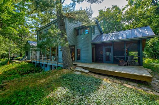 The extensive deck runs the length of the home, tying together the exterior from the screen porch to the garage.