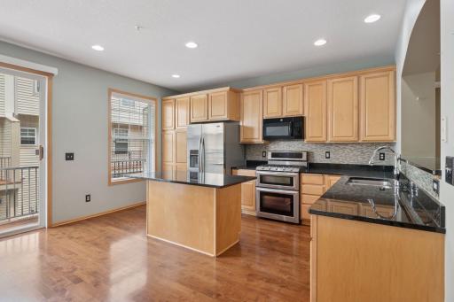 The center island kitchen has an abundance of counter space and a breakfast bar