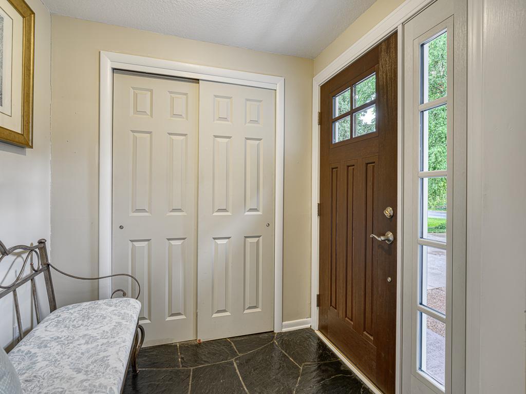 The welcoming foyer sets the tone with elegant design and abundant natural light
