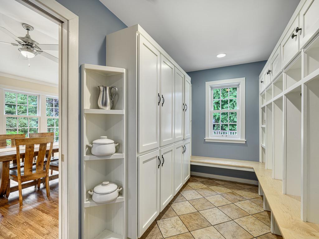 The spacious mudroom offers practical storage solutions, keeping everyday essentials organized and out of sight