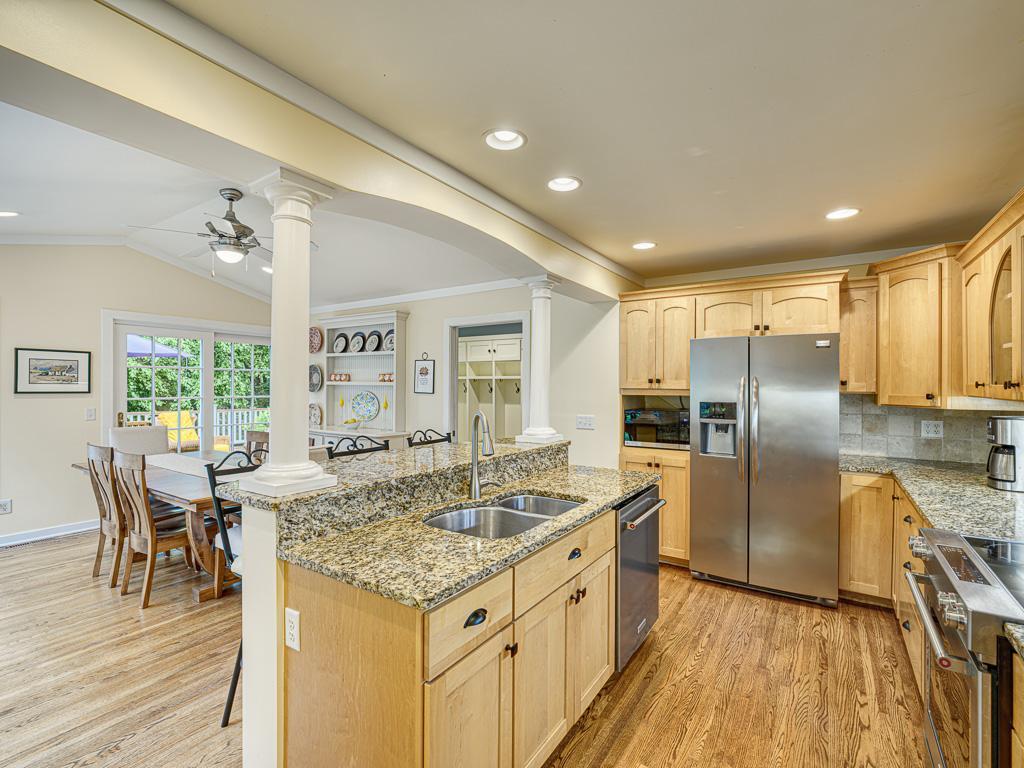 The kitchen boasts warm hardwood floors and stunning granite counters, perfect for cooking and entertaining