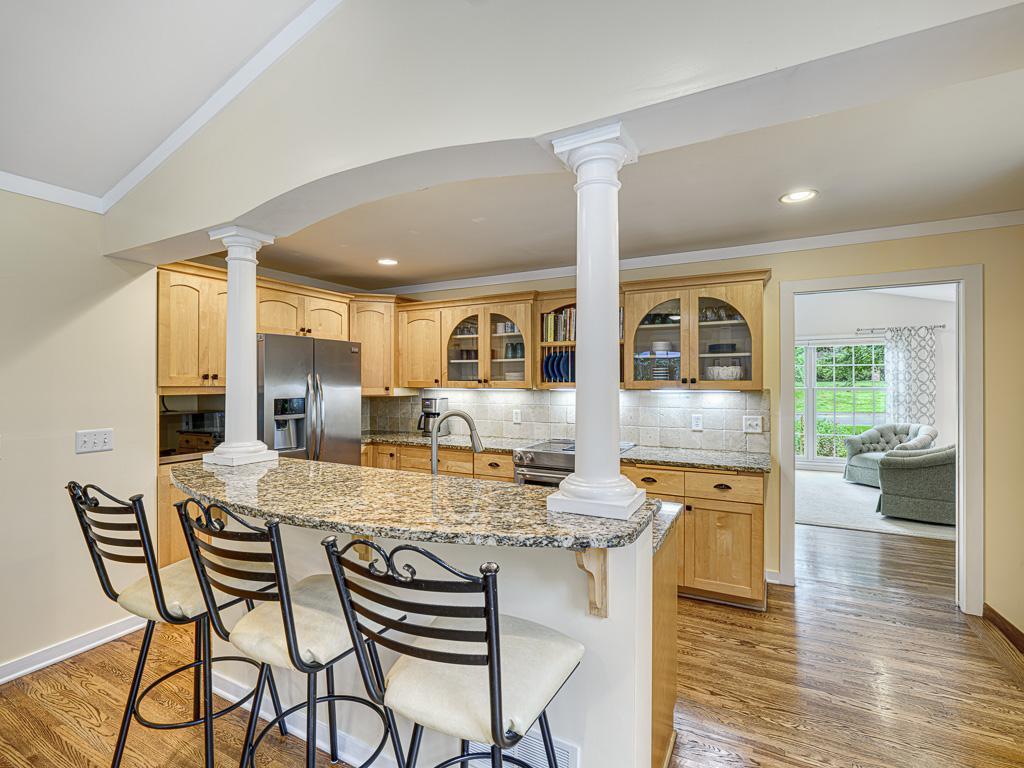 Equipped with stainless steel appliances, the kitchen seamlessly connects to adjoining living spaces for effortless entertaining