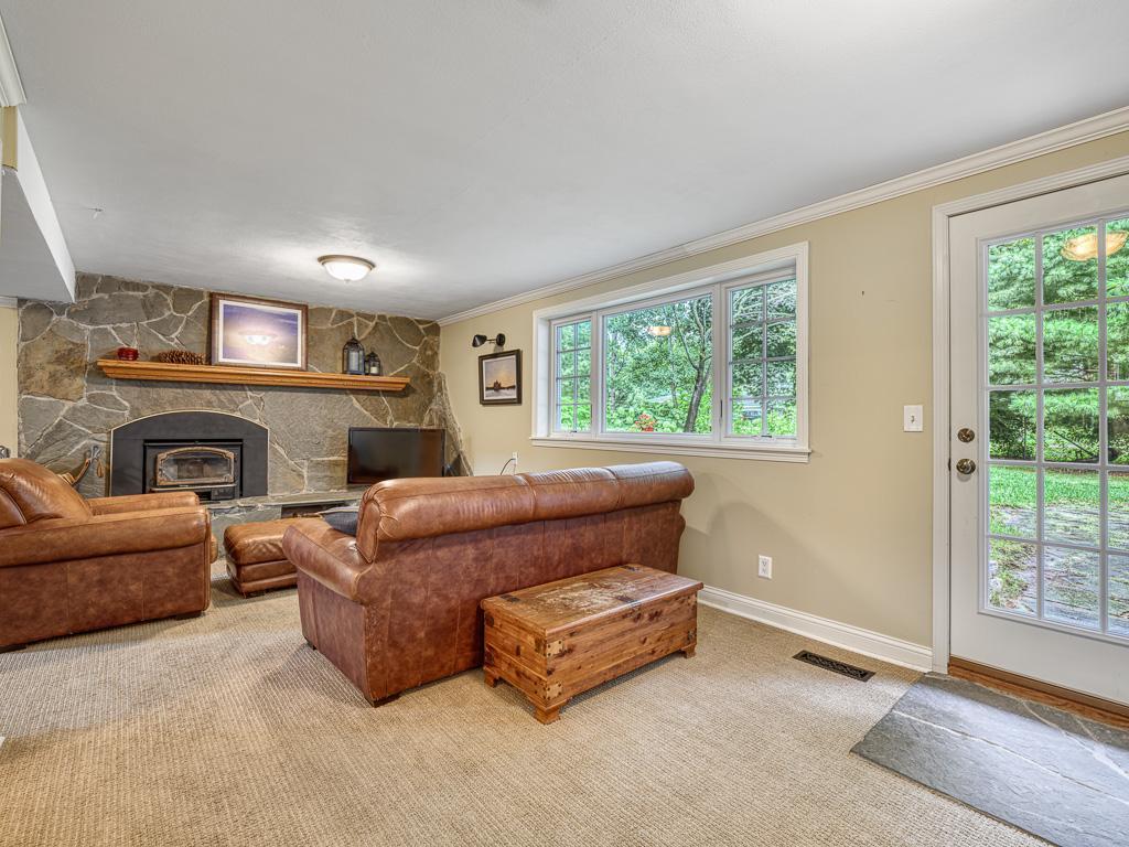Downstairs, the walkout lower level includes a comfortable family room with a charming wood-burning fireplace.