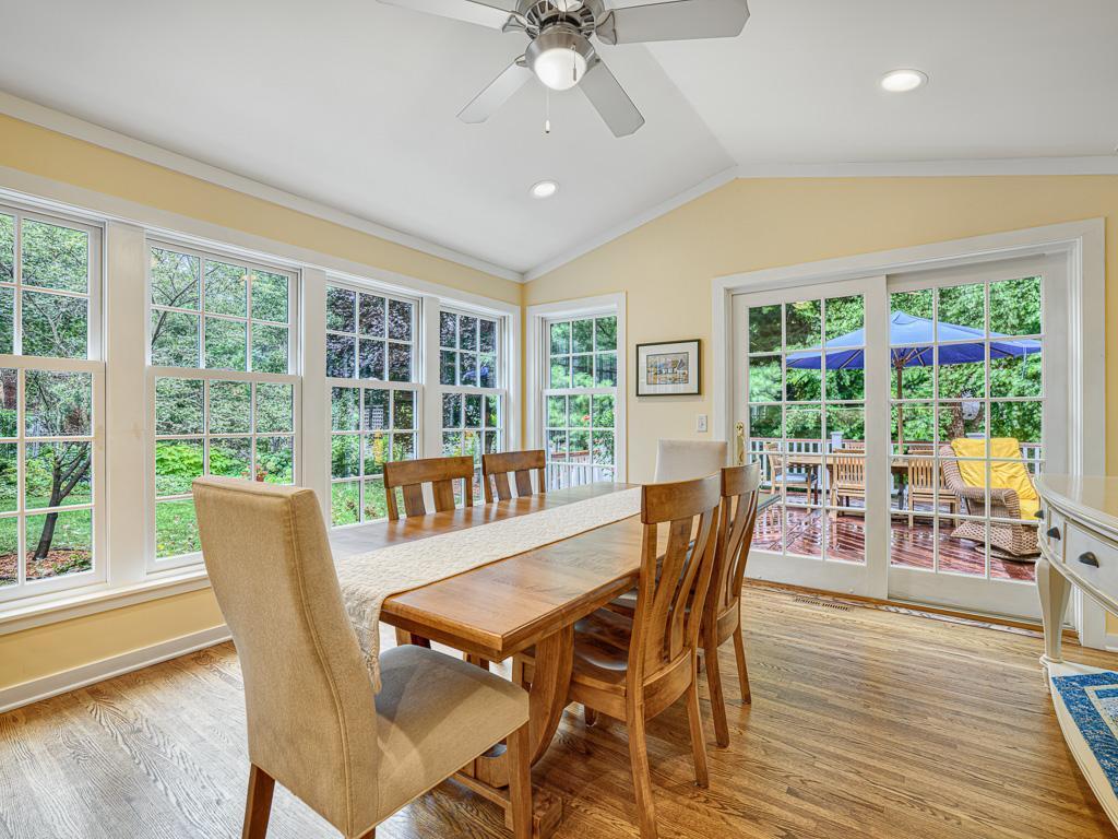 Flooded with natural light, the adjoining dining room offers stunning garden views that seamlessly connect indoor and outdoor living