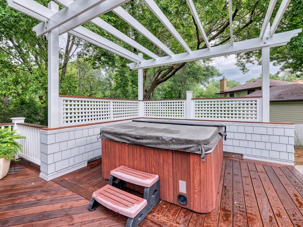The outdoor space includes a hot tub, ideal for relaxation and entertaining guests