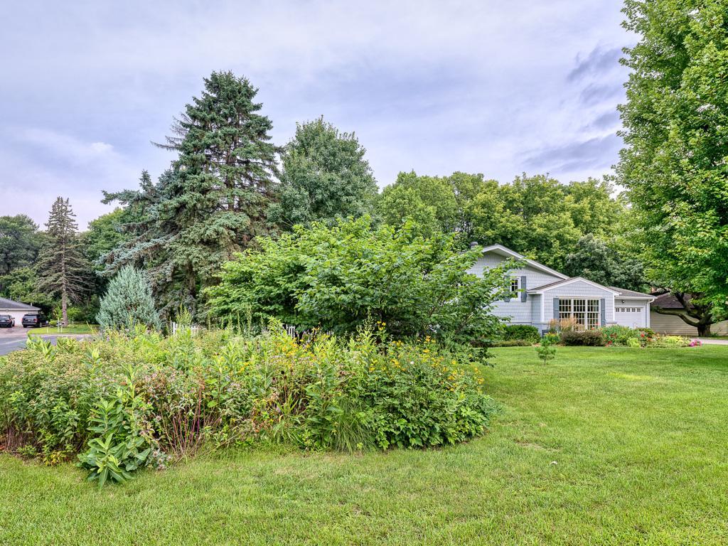 Enjoy a generous front yard featuring this lush native garden and ample space for outdoor activities