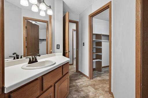 Enjoy the oversized vanity with plenty of storage space for all your bathroom essentials. Just ahead you can see the walk-in closet.