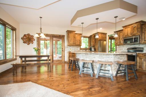 Spacious kitchen with pantry closet across dining