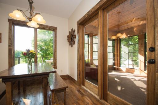 Informal dining area with walkout to three-season porch and adjoining deck