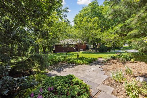 Relax on the Patio to the sounds of the water feature. Enjoy the green space beyond for lawn games!