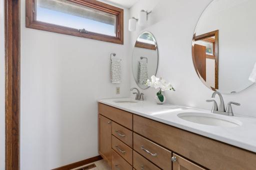 Double vanity with ample storage and natural light.