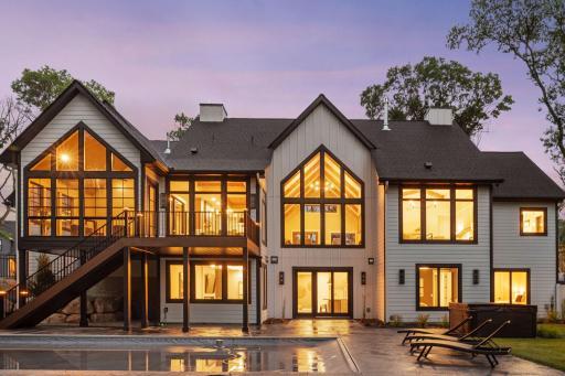 $2.395M new construction in Ham Lake featuring vaulted glass, wooded privacy, a walkout lower level, and full 3D Matterport tour available.