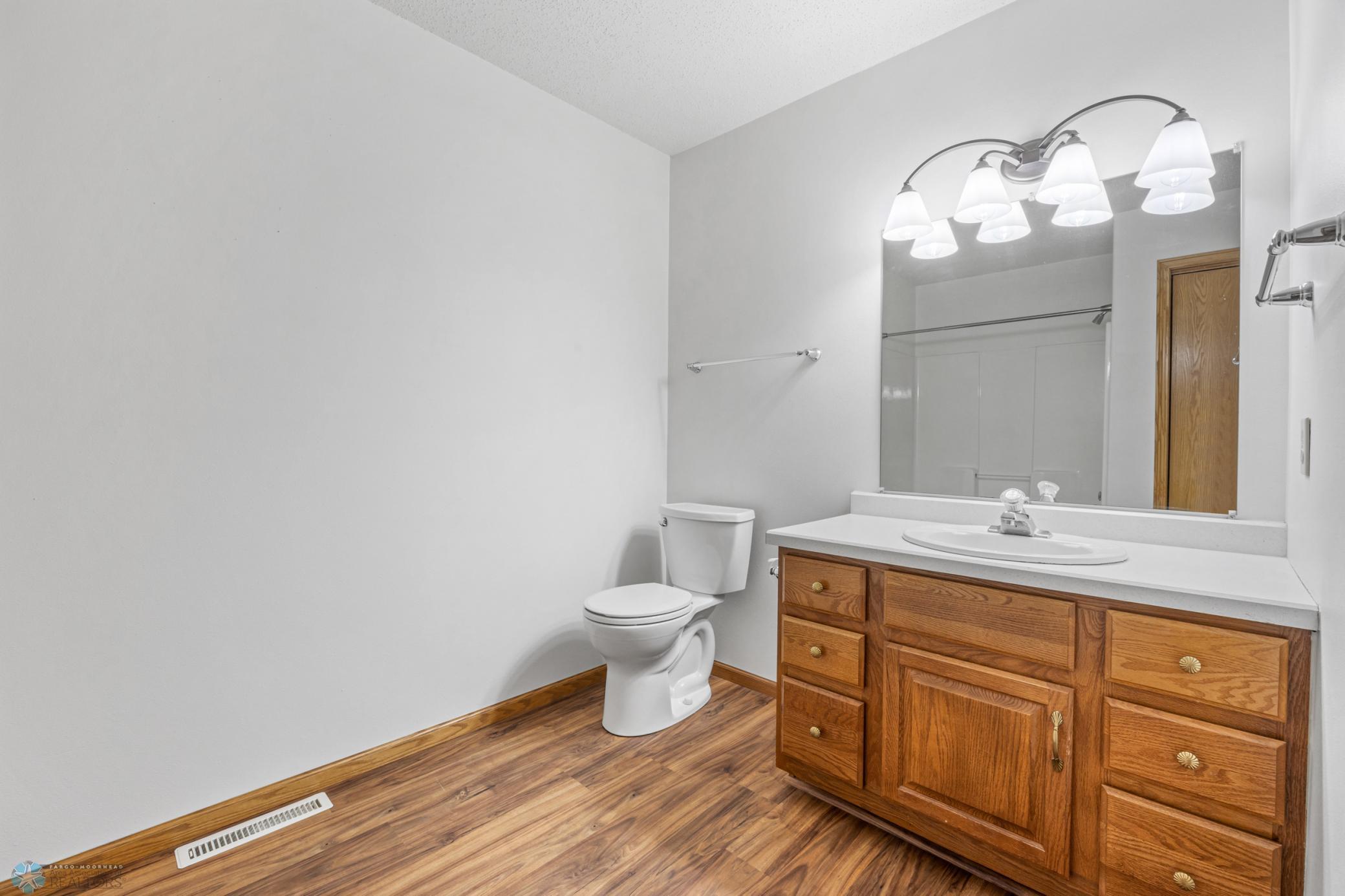 Large upper floor full bathroom has a tub/shower and a storage closet.