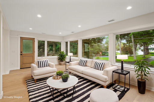 Expansive sunroom across front of house with stunning views of Lake Minnetonka! *Virtually staged