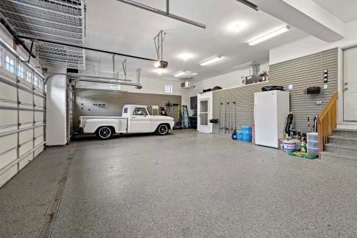 The garage is a standout with custom cabinetry and wall slats complete with accessoriesâperfect for organized storage and workspace efficiency. A durable, textured epoxy floor coating adds a sleek, high-end finish built to withstand daily use.