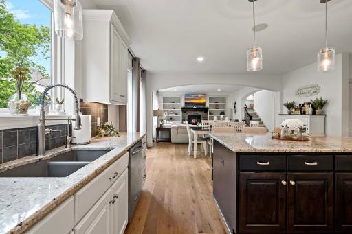 From the kitchenâs alternate vantage point, enjoy an open view overlooking the dining and living roomsâhighlighting the seamless flow and spaciousness perfect for entertaining and everyday living.