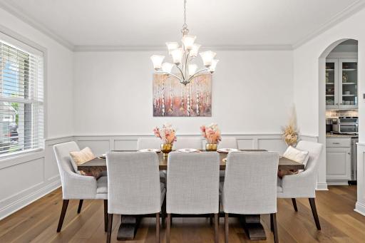 As you enter, youâre immediately greeted by the stunning formal dining space, where graceful archways and elegant wainscoting set the tone for unforgettable gatherings and refined living.