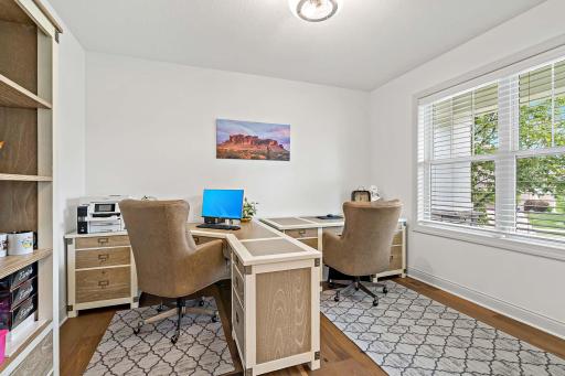 The spacious office, accessible through elegant French doors off the main living area, offers a bright and private workspace.