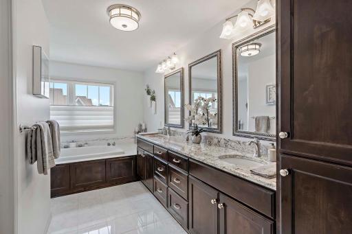 The ownerâs bath features double sinks, a luxurious soaker tub, and a spacious walk-in showerâcombining style and comfort for a true spa-like experience.