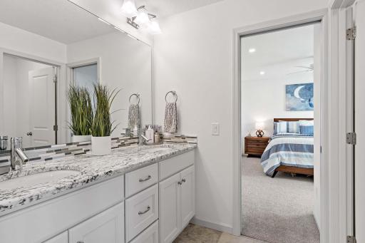 The Jack and Jill bathroom features double sinks and a separate shower area, offering convenience and privacyâperfect for busy mornings or shared living without compromise.