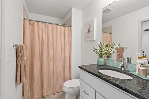 This updated bathroom features a modern 3/4 shower, combining style and functionality with contemporary finishes.