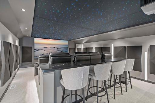 Experience cinematic luxury with a $195K custom Dolby Atmos projection theater, featuring a native 4K laser projector, 133" screen, custom racking with duct cooling, and a 15.2 A/V system powered by high-end amplifiers and filters.
