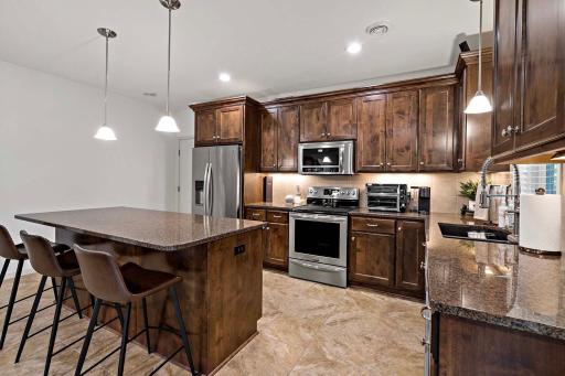 Lower level features spacious living with a full kitchen, providing an ideal setup for entertaining, guests, extended family, or multigenerational living.