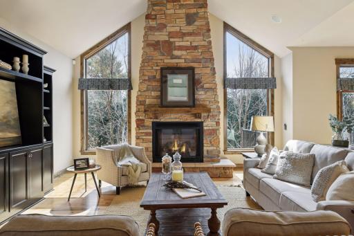 The oversized, near floor-to-ceiling windows flood the home with natural light while perfectly framing the beautiful and private backyard views.