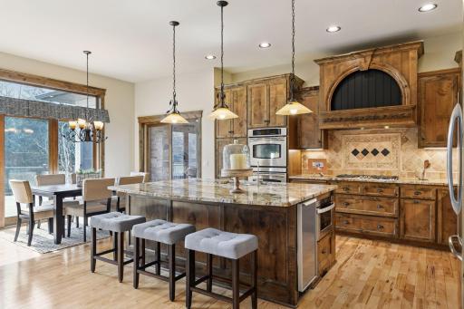 The main living room, kitchen area offers a spacious feel with generously sized rooms and soaring ceilings, creating an open and airy atmosphere. Note the Ice maker built into the center island. There is a wine refrigerator also!