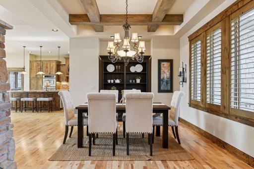 The formal dining area showcases an elegantly crafted wood box-beamed ceiling, adding a touch of sophistication and architectural charm to the space
