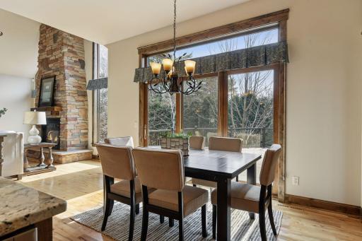 A triple set of patio doors, topped with a transom window, opens to the deck, seamlessly blending indoor and outdoor living.