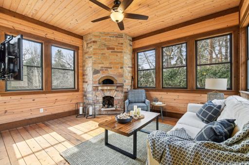 Off the kitchen is a fabulous sunroom, complete with a wood fired pizza oven imported from Italy, offering a perfect blend of warmth and culinary charm.