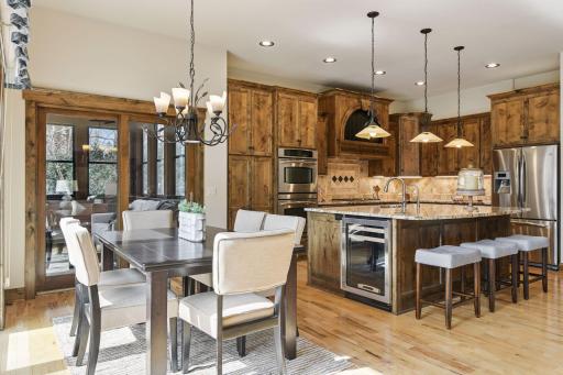The additional informal dining area overlooking the backyard is both functional and versatile, providing a convenient space for everyday meals while capturing calming views of the outdoor scenery.
