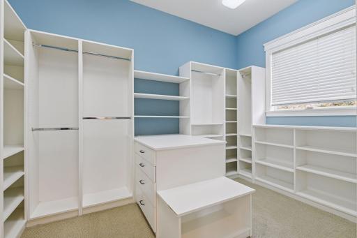 The walk-in closet is nearly as large as the bedroom, offering an abundance of space. The photo fails to fully capture the vastness of this impressive owner's closet.