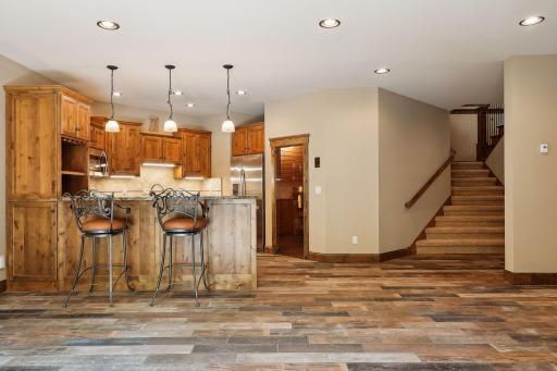 Versatile and functional, the lower family room offers a wonderful space for a variety of uses. The 9-foot ceilings enhance the spacious feel, and recent upgrades include ceramic tile flooring that beautifully emulates hardwood.