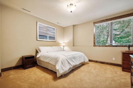 The lower bedrooms are exceptionally spacious and feature large windows that flood the rooms with natural light.