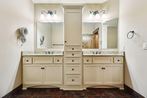 The lower full bath features dual vanities and includes a separate tub and shower room for added convenience.