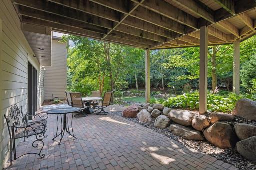 Flowing directly from the lower walkout, the patio serves as a convenient transition between indoor and outdoor living. Large sliding glass doors allow natural light to flood the interior while offering easy access to the enchanting outdoor area