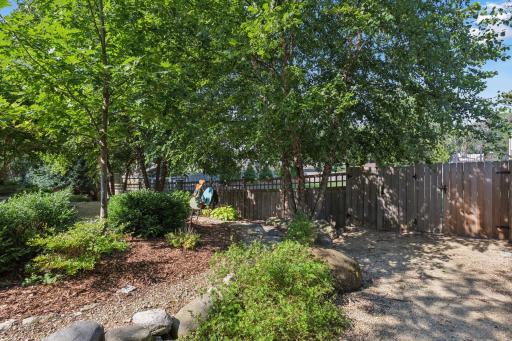 Nestled in a picturesque setting, this stunning home is surrounded by extensive landscaping that seamlessly blends natural beauty with thoughtful design, a harmonious retreat that embodies the essence of outdoor living