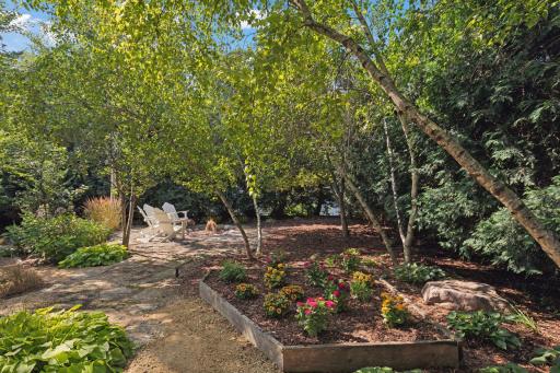 Escape the noise of leaf blowers! The entire yard is fully landscaped, eliminating the need for a lawn mower or weekly lawn service.